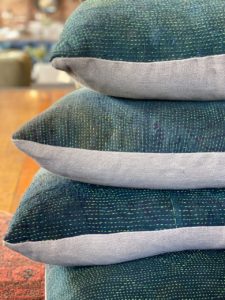 High Point Market Fall 2020. Aloka booth. Pile of three blue pillows.