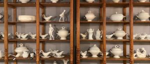 High Point Market Fall 2020. Schwung Home booth. Cabinet display of porcelain figurines. 