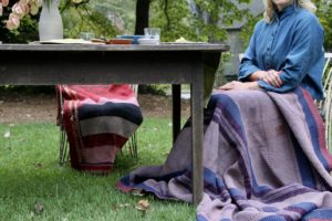 Outdoor shoot for Garnish & Gather. R. Wood pottery, Tulsi sitting on chair with Aloka quilt, runner from Hable Construction.